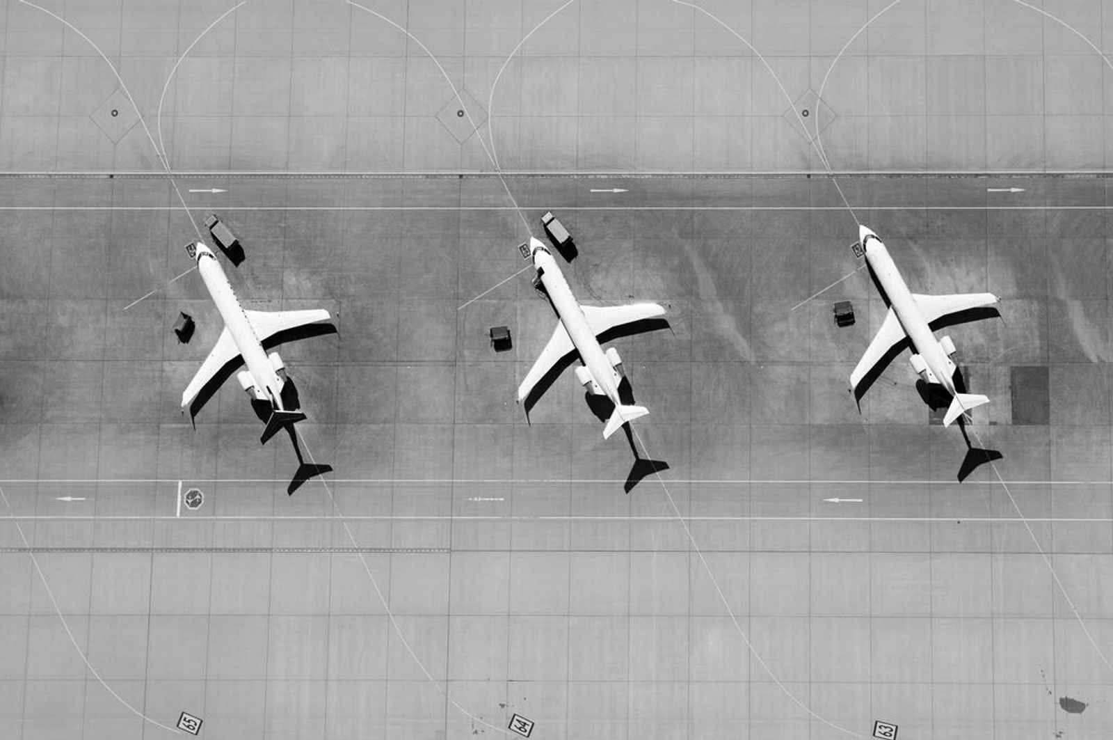 Aerial view of three airplanes in a row